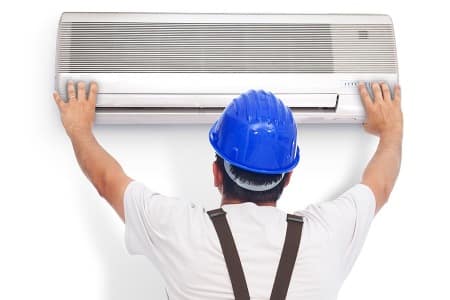 Worker opening an aircon for water cleaning